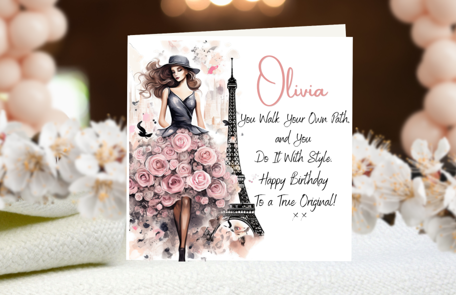 Stylish Girl In Paris Birthday card featuring a stylish woman in a floral dress and an Eiffel Tower illustration.